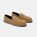 Pair of tan loafers on a white background