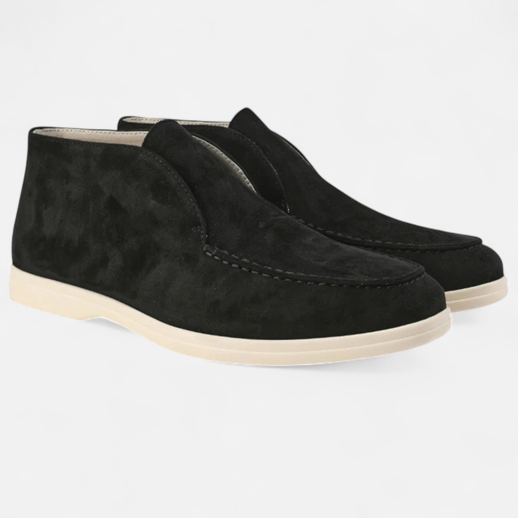 Pair of black suede shoes on a light gray background