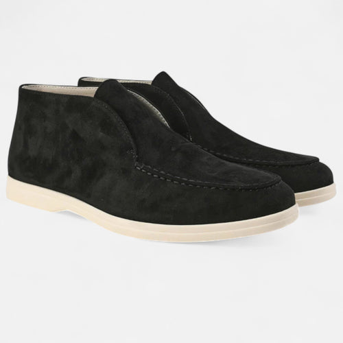 Pair of black suede shoes on a light gray background