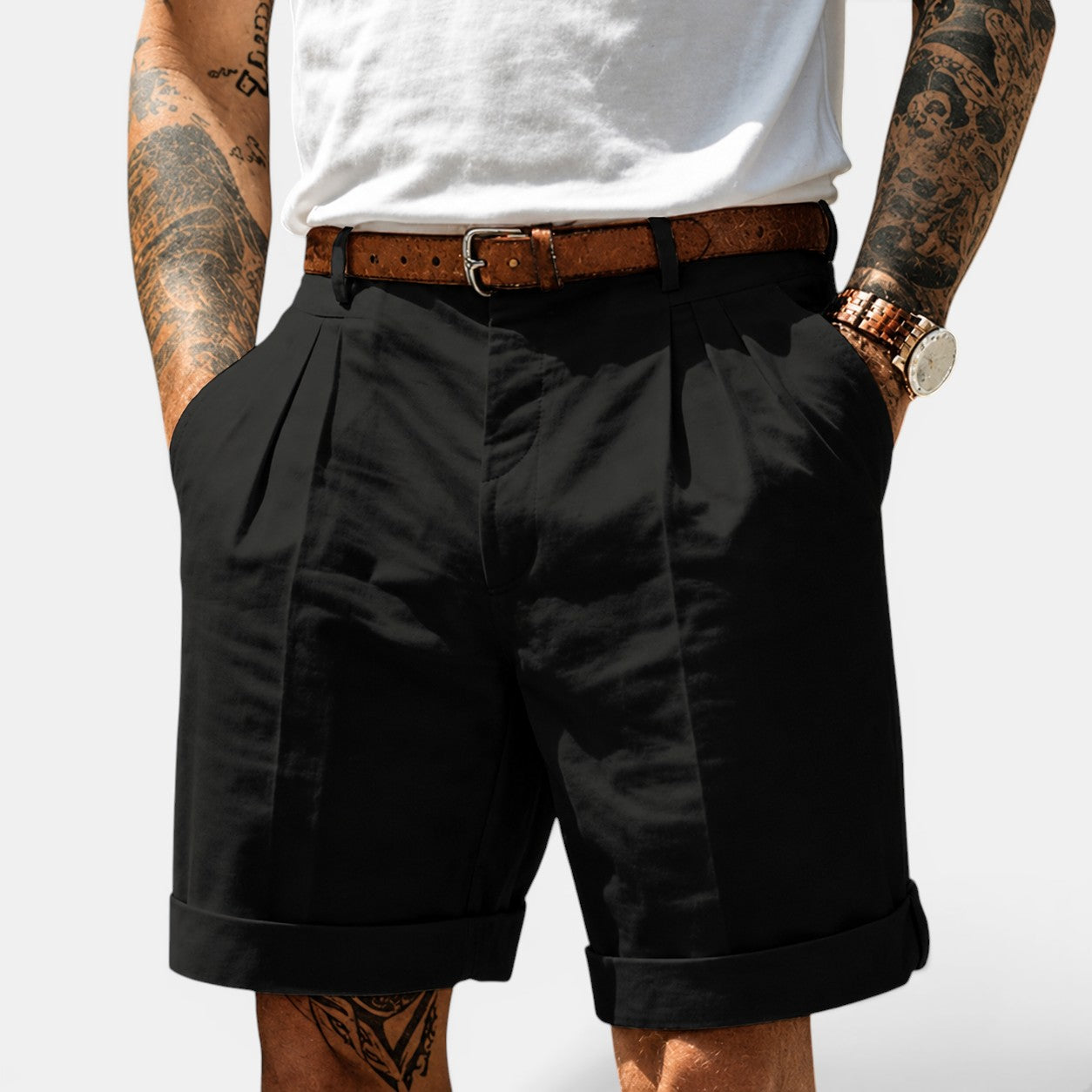 Person wearing black shorts with a white background
