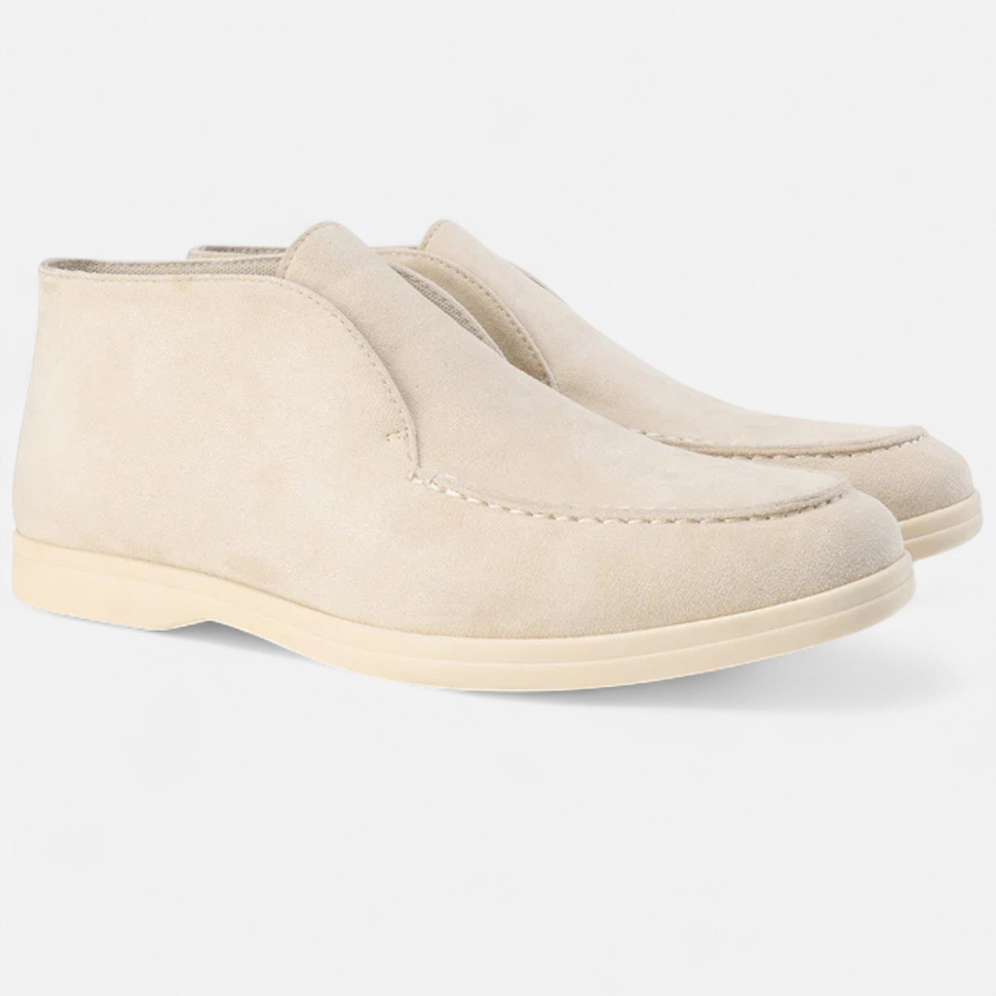 Pair of beige loafers on a white background