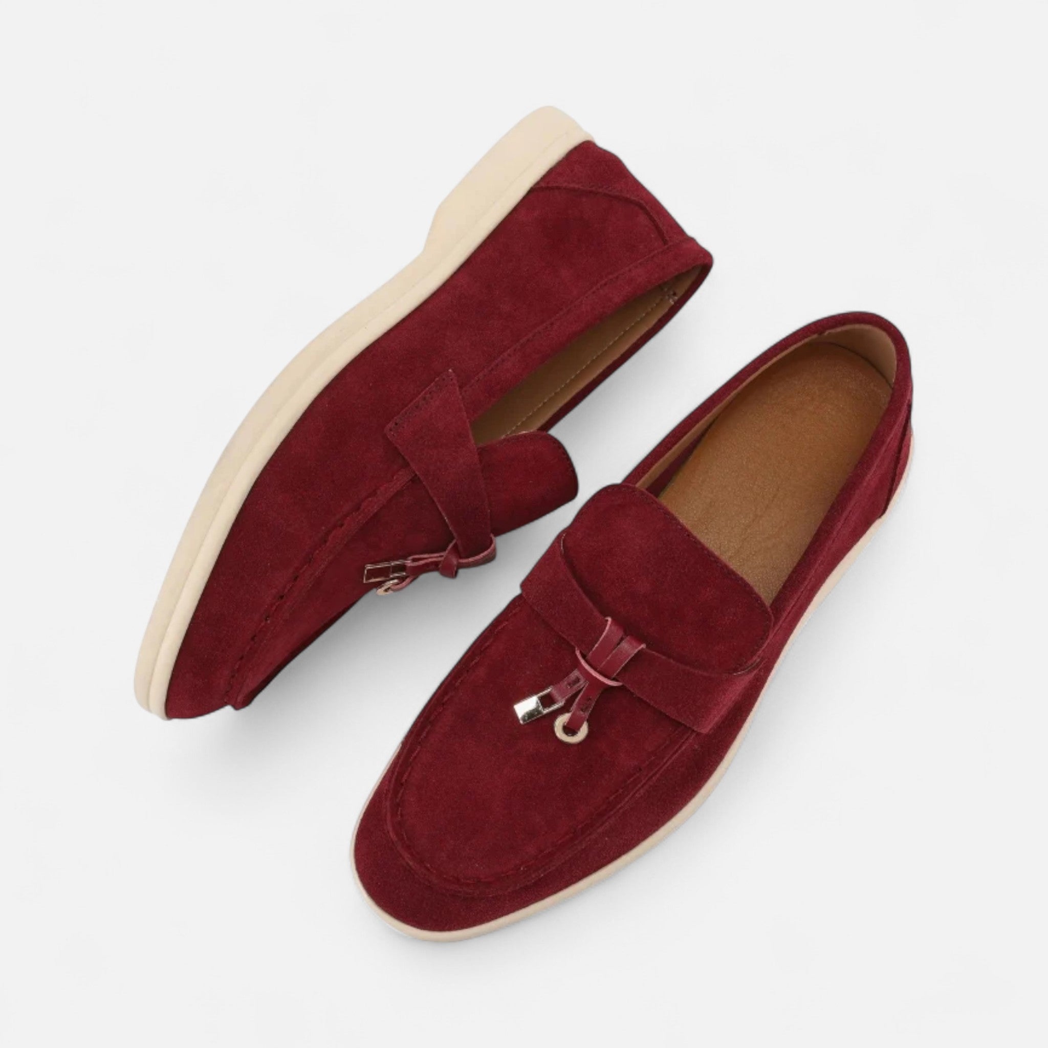 Pair of red loafers on a white background