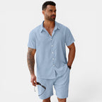Man wearing a light blue striped shirt and shorts set on a white background