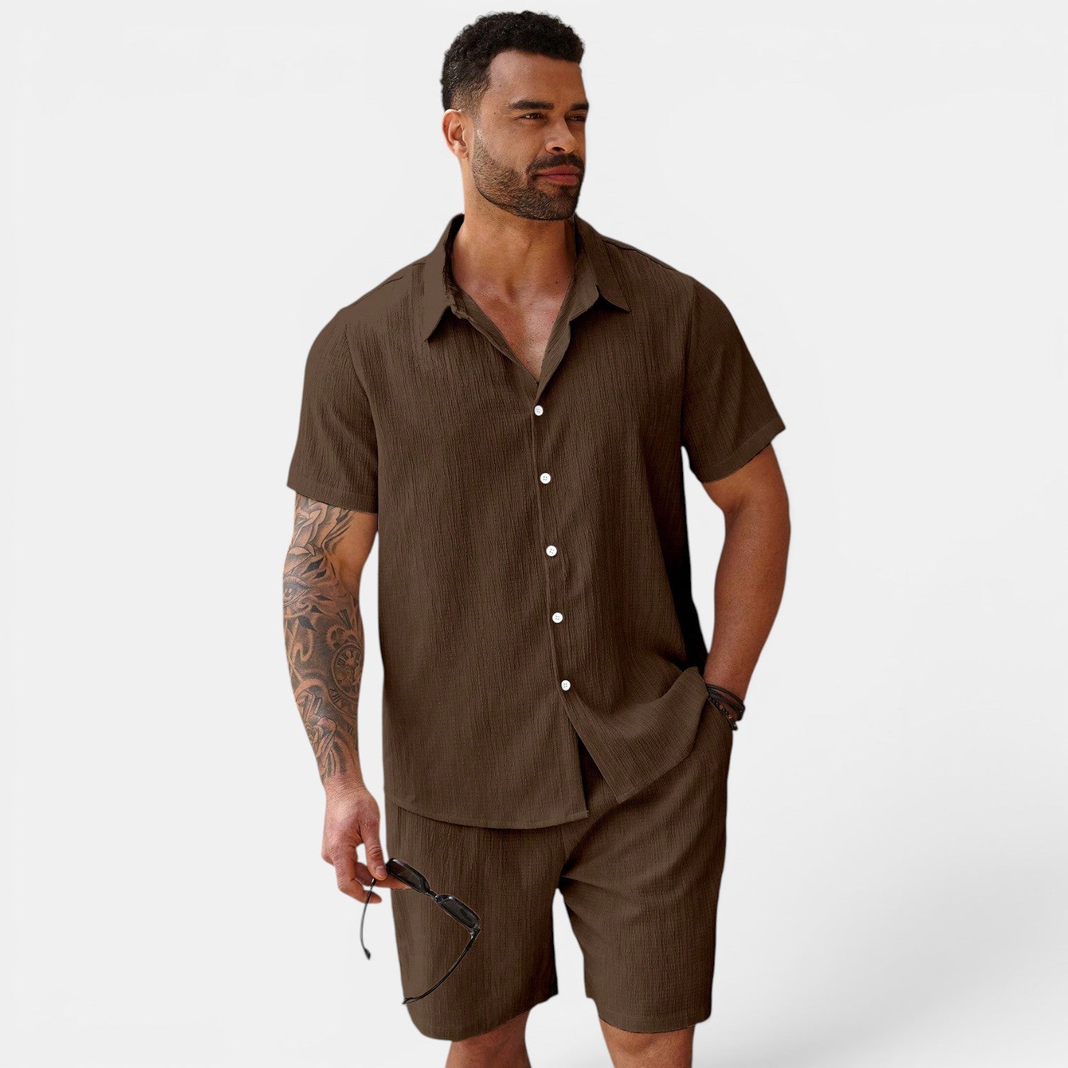 Man wearing a brown shirt and shorts set on a white background