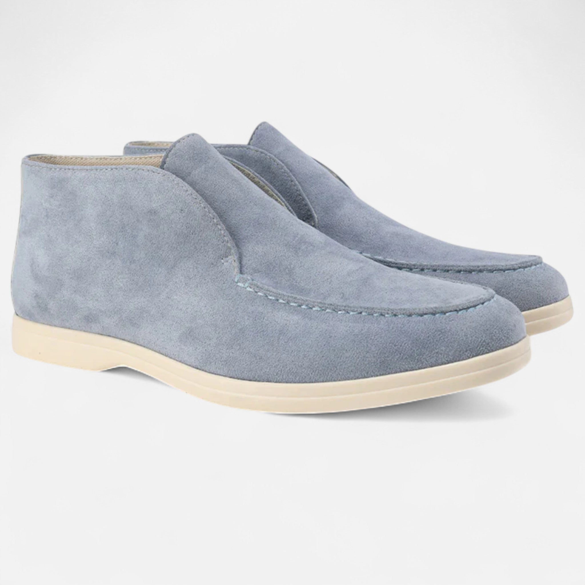 Pair of light blue suede shoes on a white background