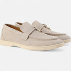 Pair of beige loafers on a white background