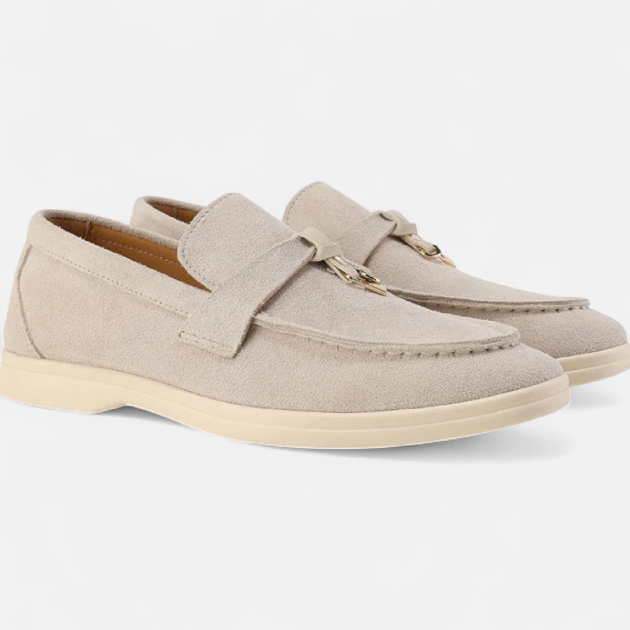 Pair of beige loafers on a white background