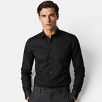 Man wearing a black dress shirt against a white background