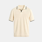Beige polo shirt with black trim on a light gray background