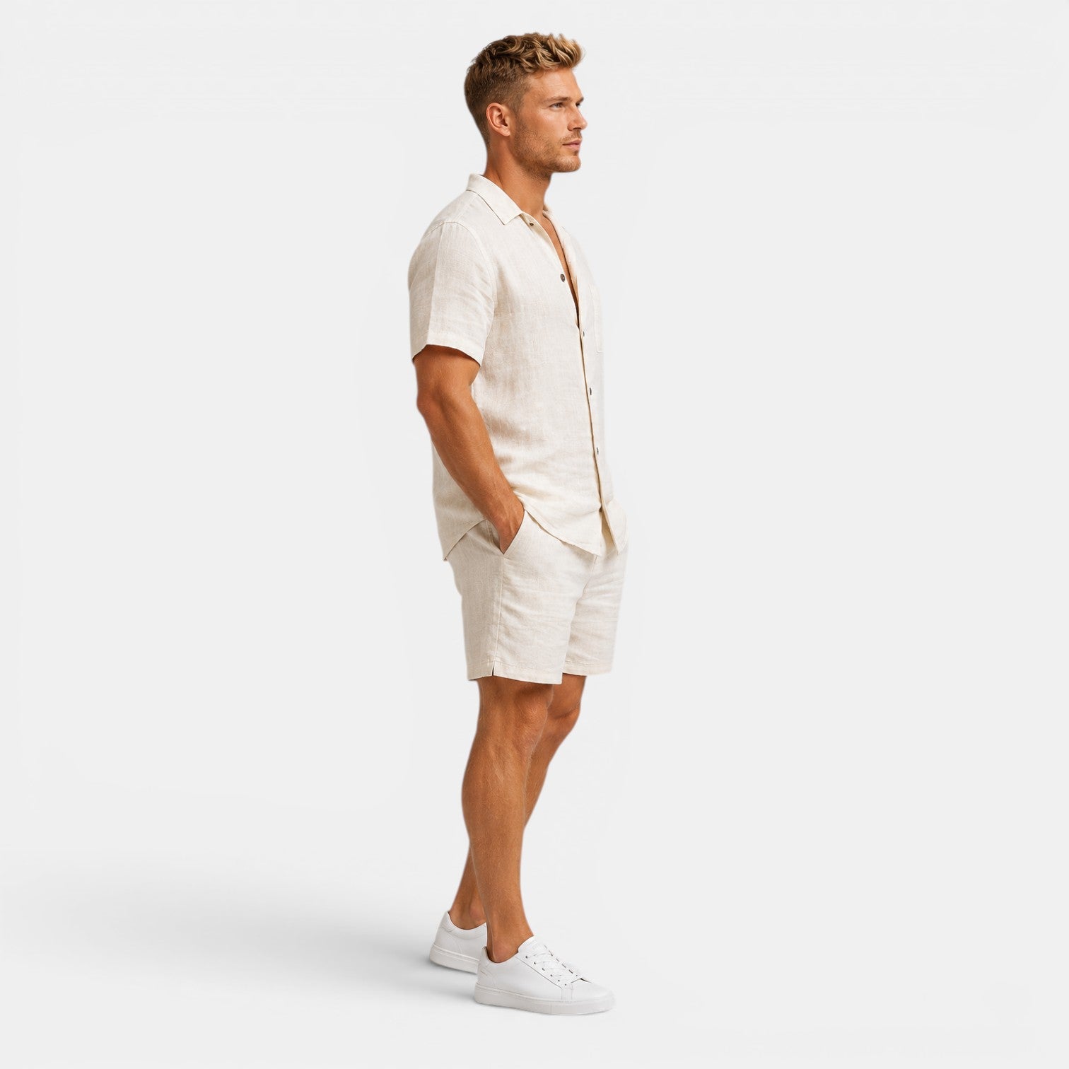 Man wearing a white linen outfit on a plain background