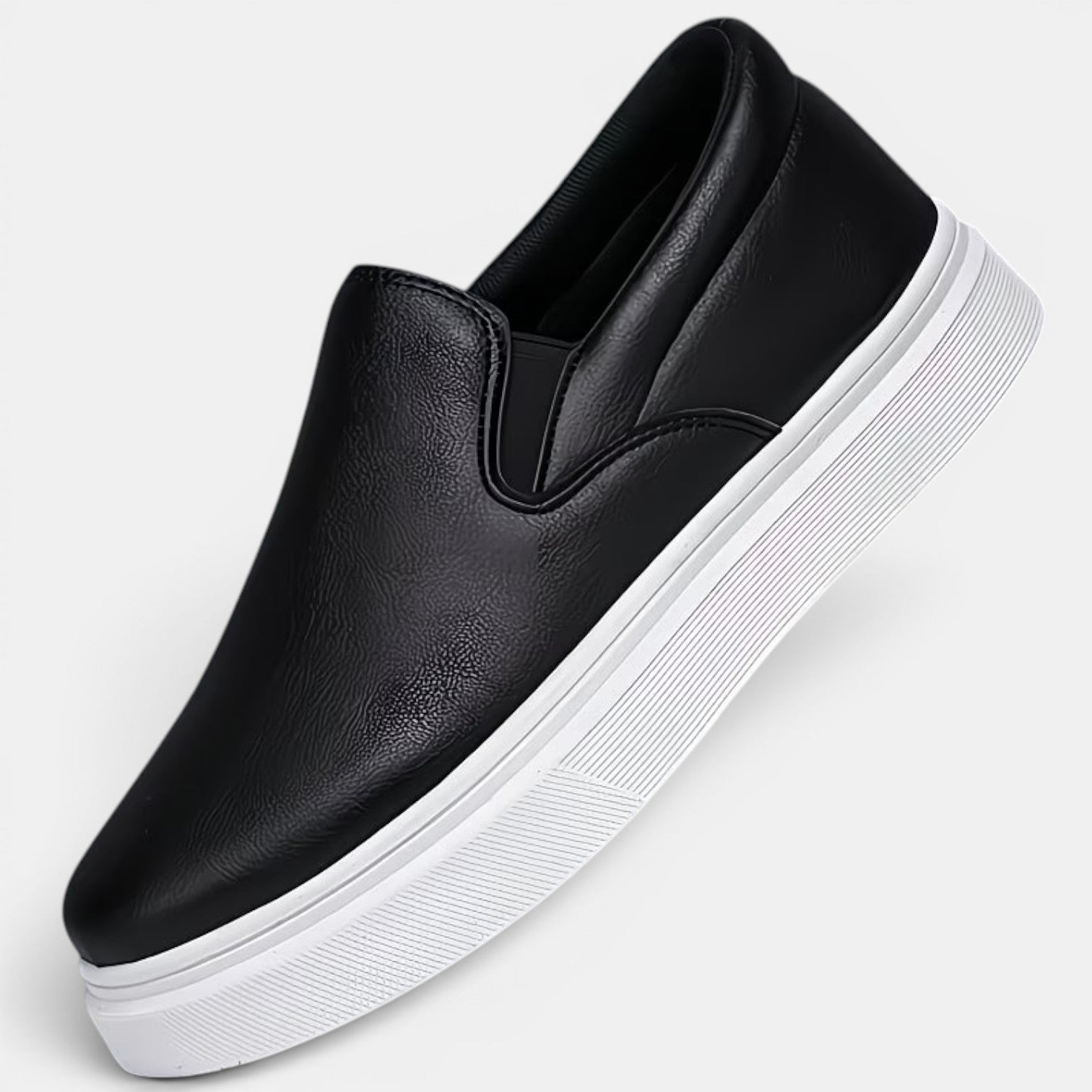 Black slip-on sneaker with a white sole on a light gray background