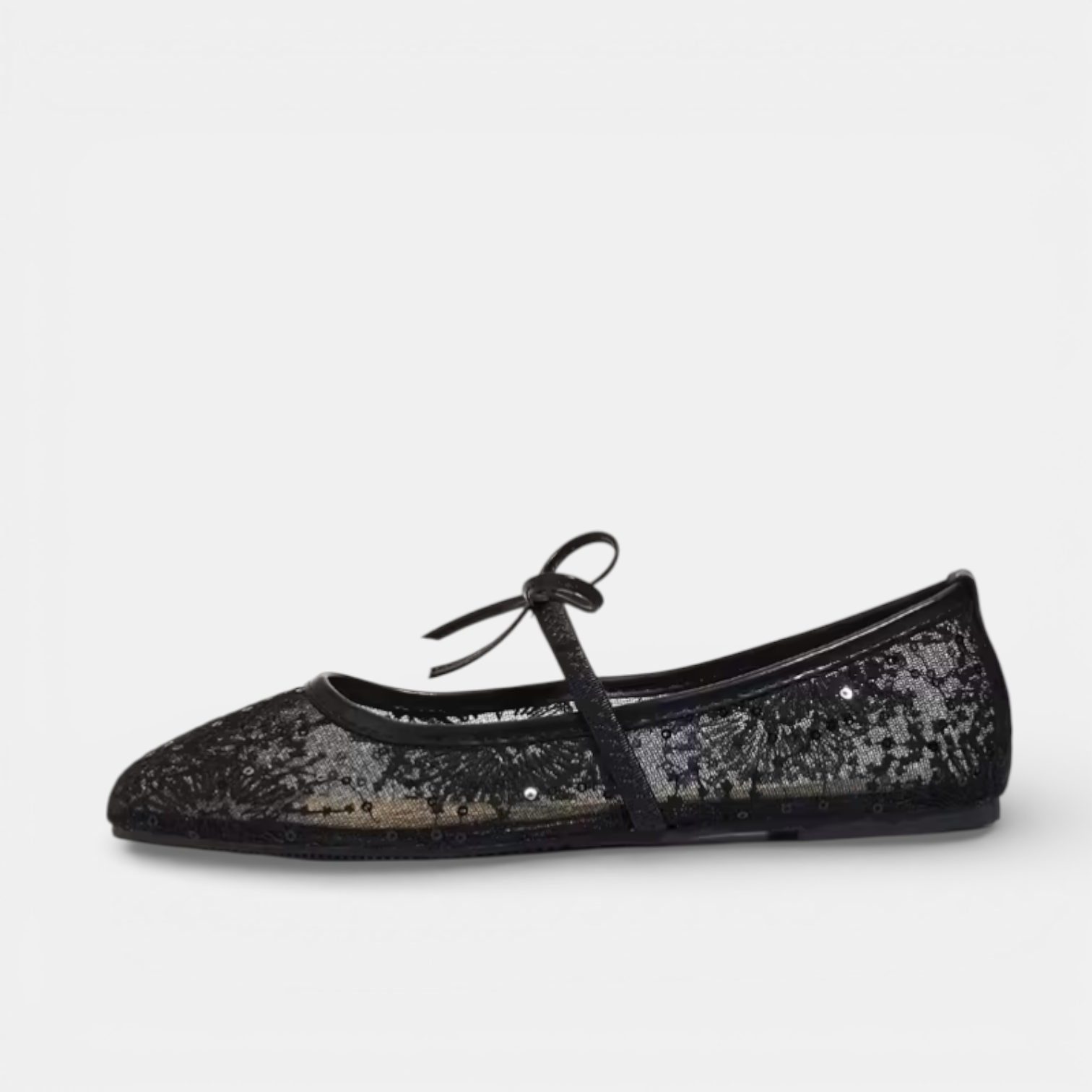Black glittery ballet flat shoe on a white background