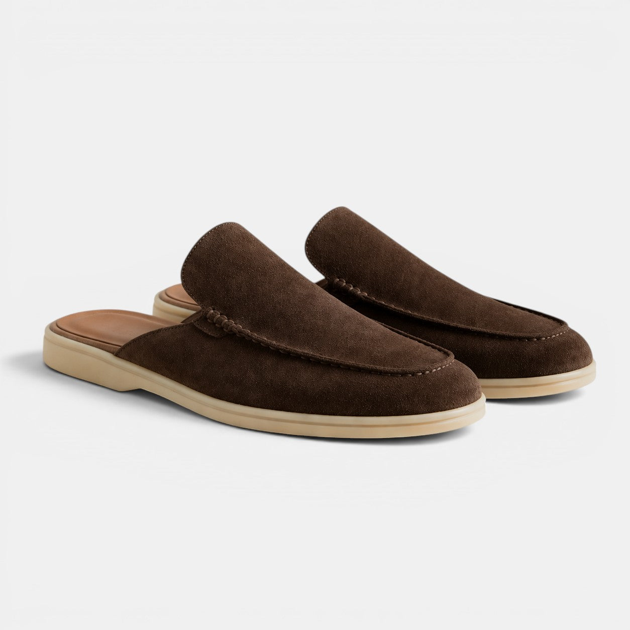 Pair of brown slippers on a white background