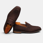 Pair of brown loafers on a light gray background