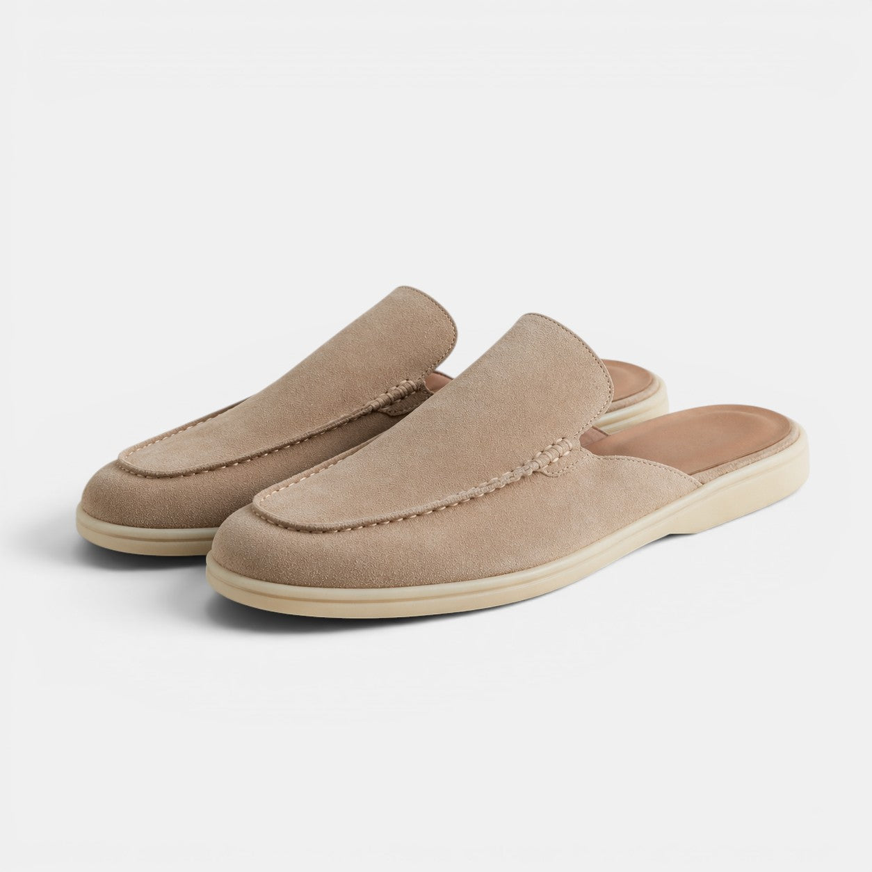 Pair of beige loafers on a white background