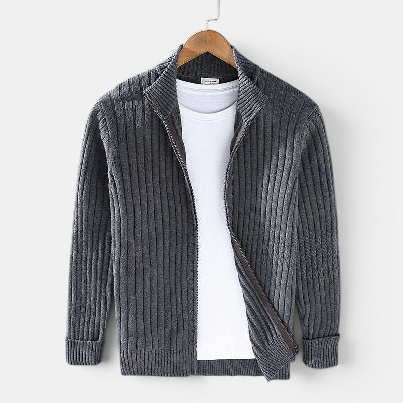 Gray ribbed sweater on a hanger against a white background
