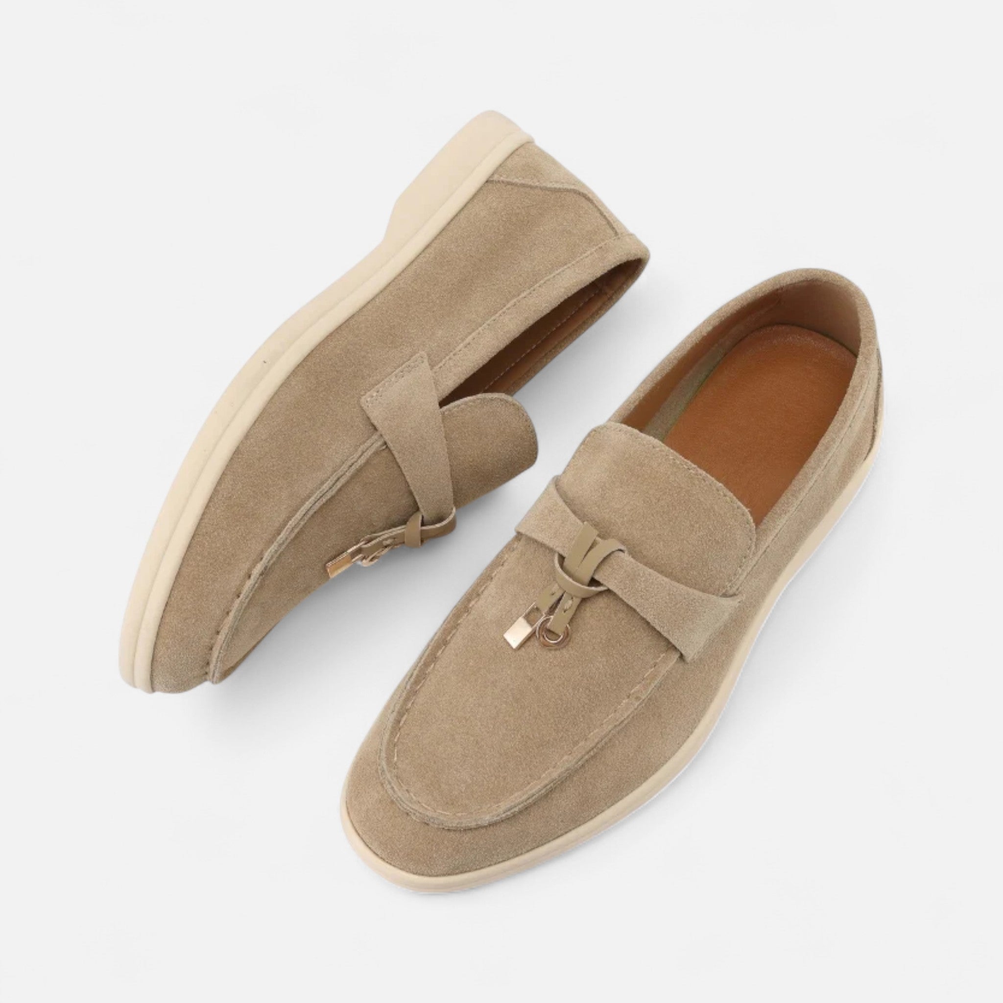 Pair of tan loafers on a white background