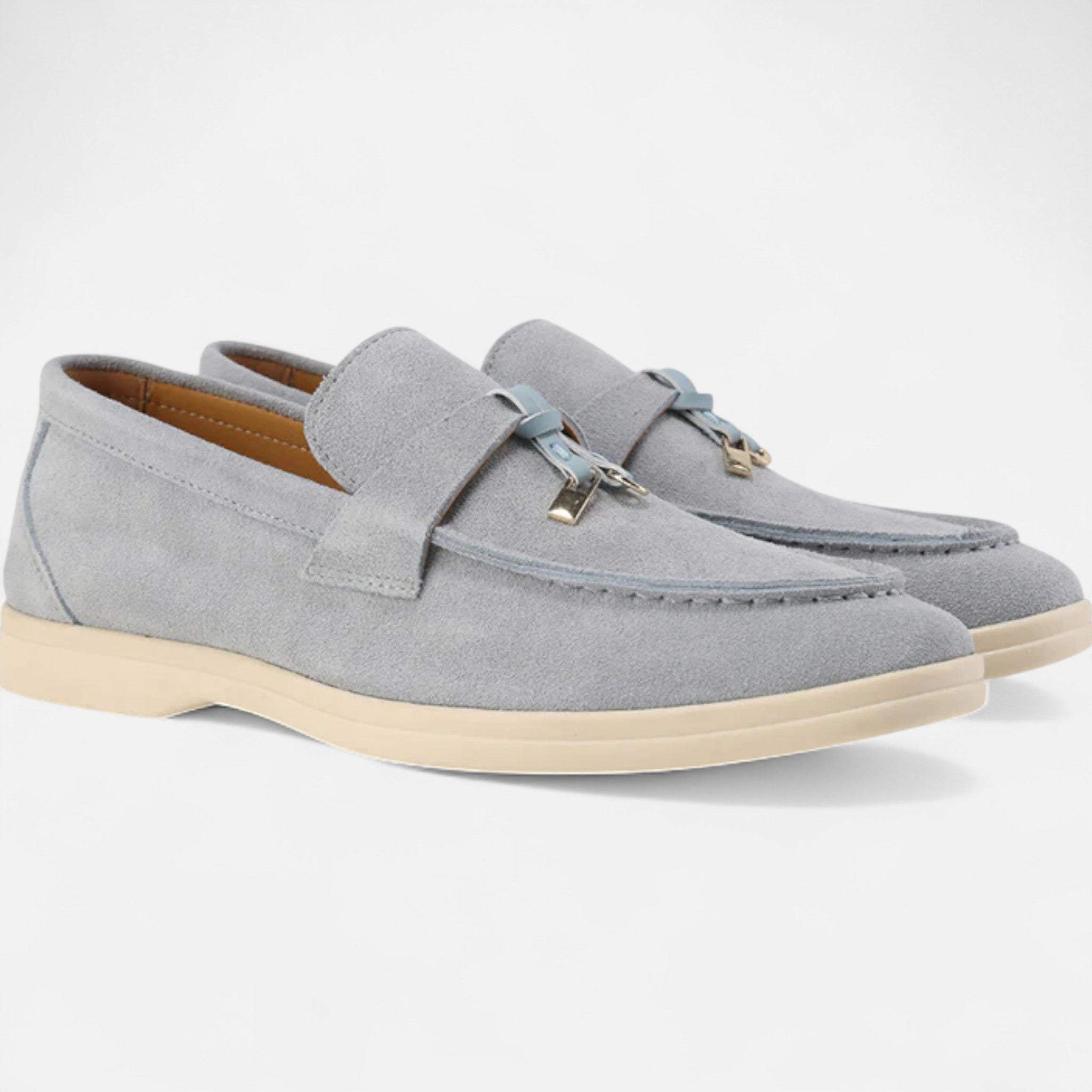 Gray loafers with beige soles on a white background
