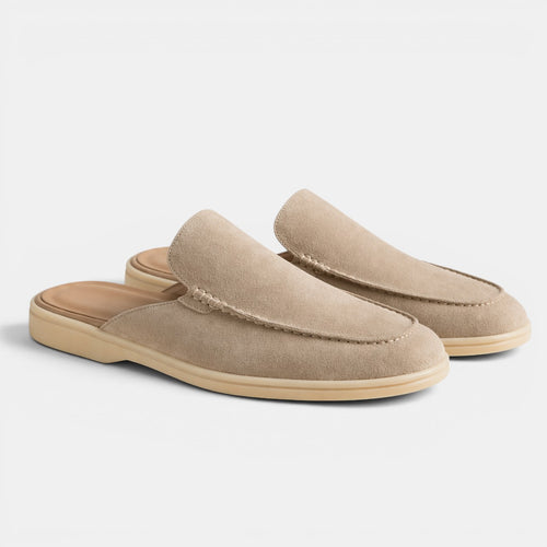 Pair of beige slippers on a light gray background