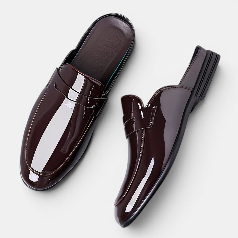 Pair of glossy brown loafers on a white background
