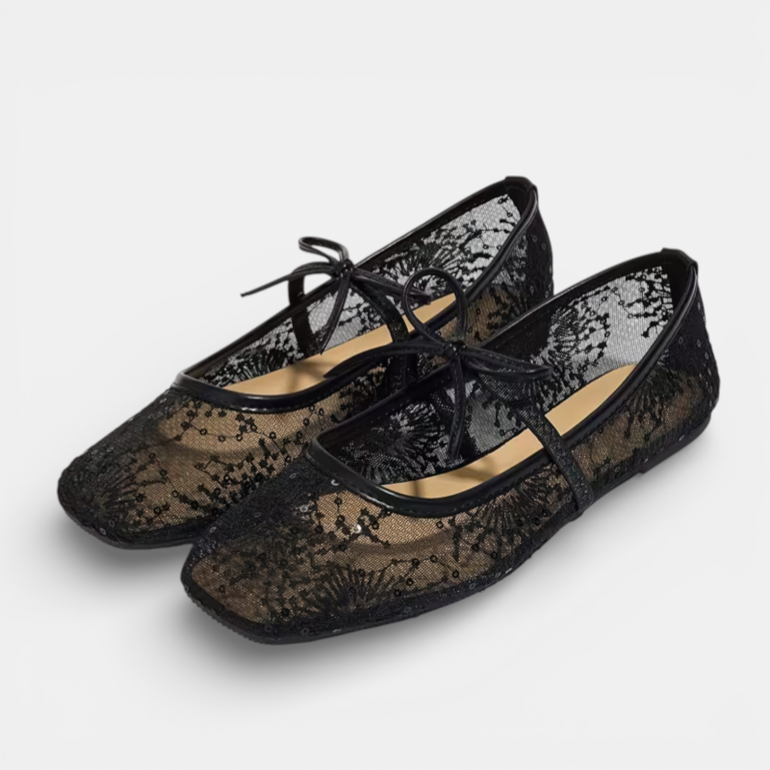 Black lace shoes on a light gray background