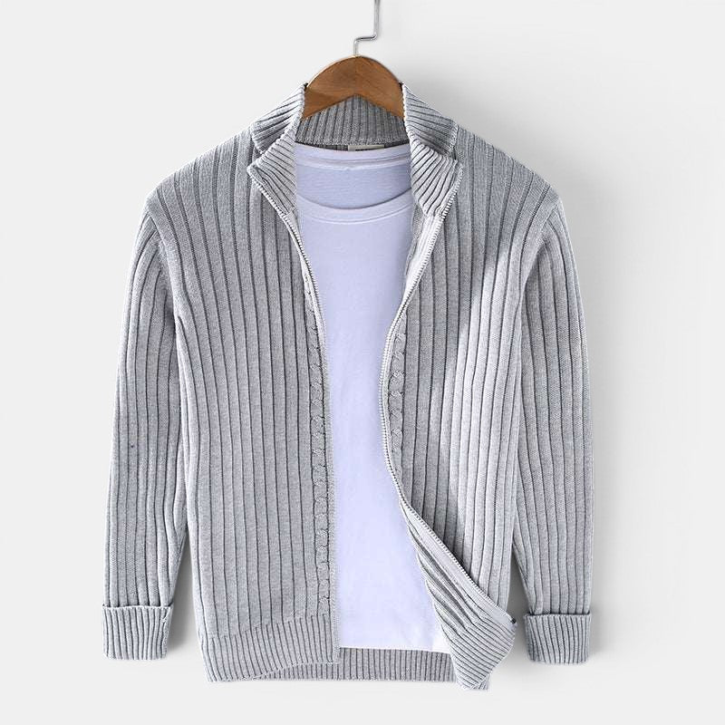 Gray ribbed sweater on a hanger against a white background