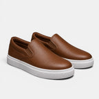 Brown slip-on sneakers with white soles on a light gray background
