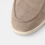 Close-up of a brown slipper on a light gray background