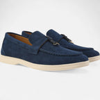 Pair of blue loafers on a white background