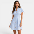 Woman wearing a blue and white striped dress on a white background