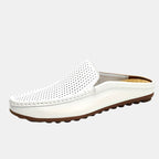 White loafer shoe with brown sole on a light gray background