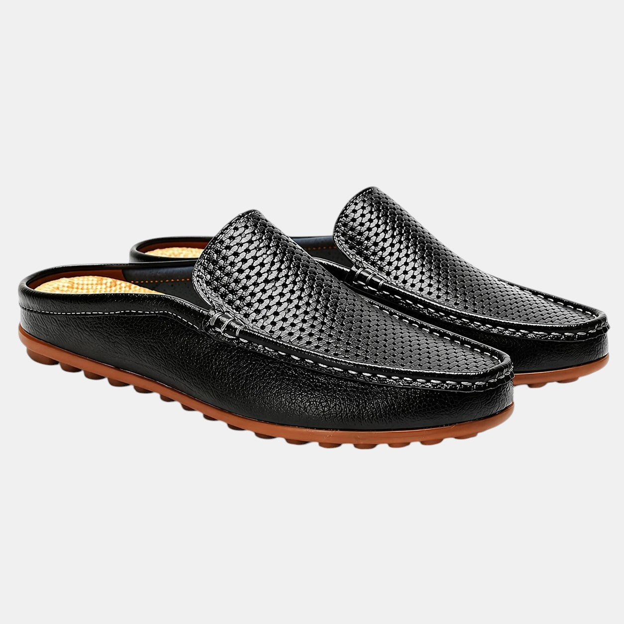 Pair of black woven loafers on a light gray background