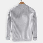 Gray ribbed sweater on a wooden hanger against a white background