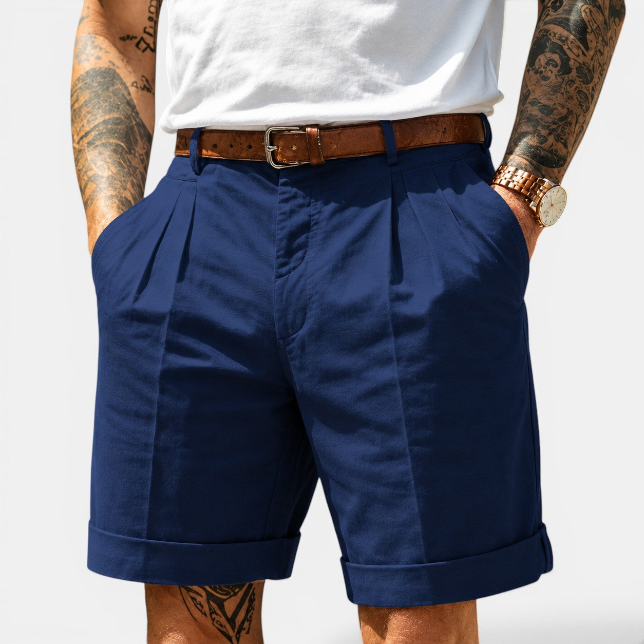 Person wearing navy shorts with a white background