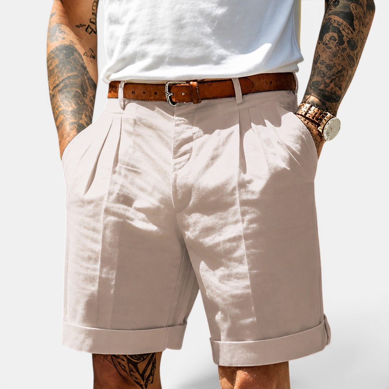 Person wearing beige shorts with a white background