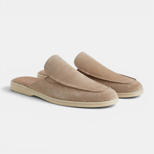 Pair of beige loafers on a white background