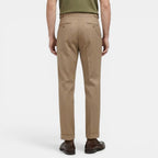 Person wearing beige pants on a white background