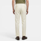 Person wearing beige pants on a white background