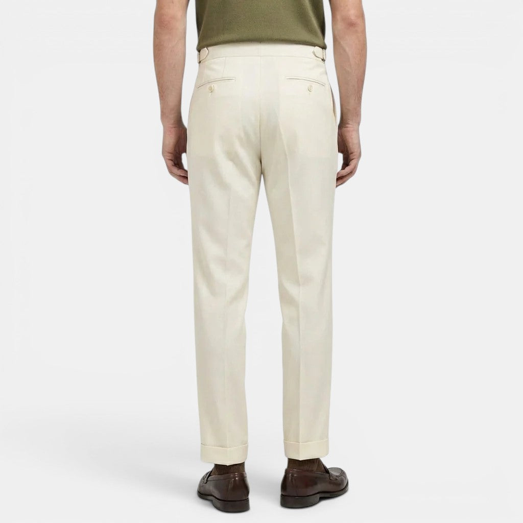 Person wearing beige pants on a white background
