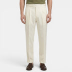Person wearing beige dress pants on a white background