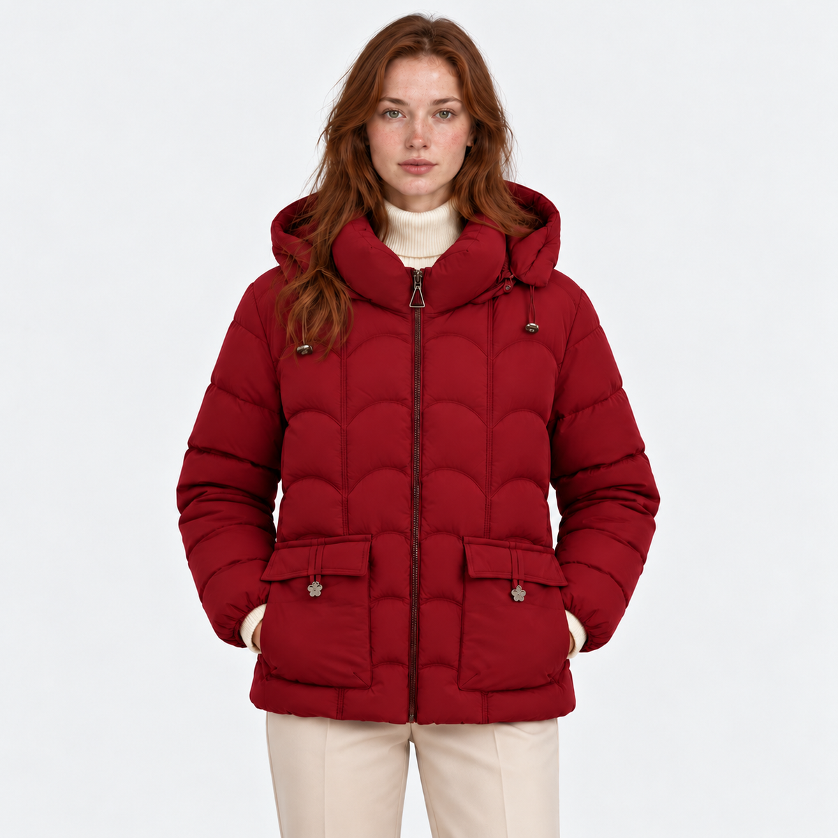 Women's red quilted puffer jacket with hood, front zipper, and flap pockets