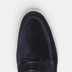 Navy blue loafer shoe on a light gray background