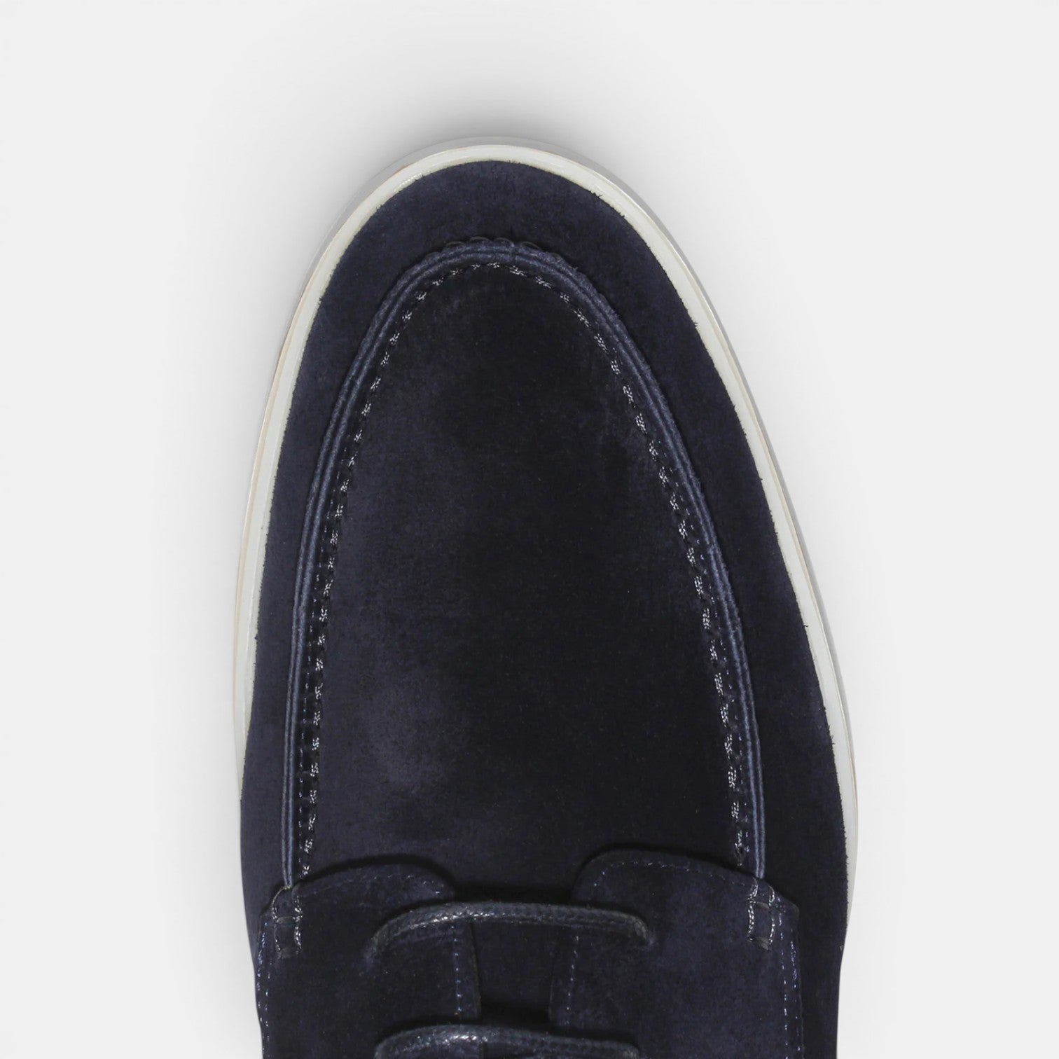 Navy blue loafer shoe on a light gray background