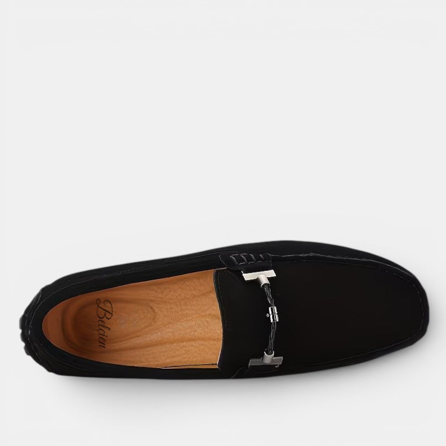 Black loafer shoe with a wooden insole on a white background