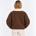 Back view of a woman wearing a brown shearling collar jacket