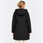 A woman viewed from the back wearing a black quilted hooded coat over cream pants, photographed against a clean light gray studio background.
