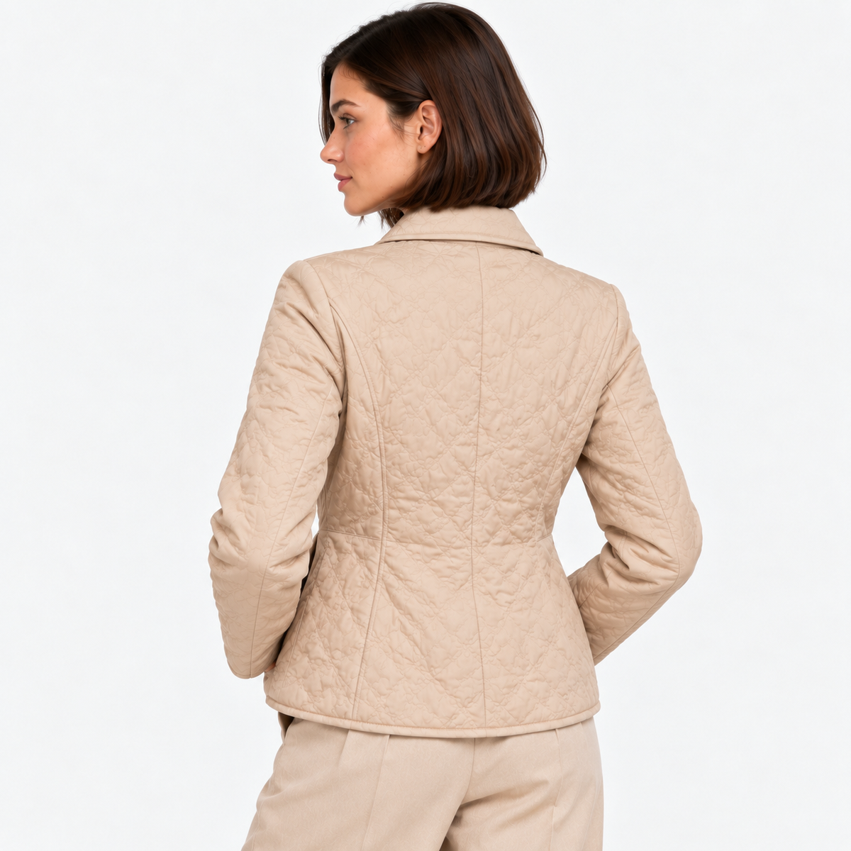 Back view of a women's beige quilted jacket with a classic collar