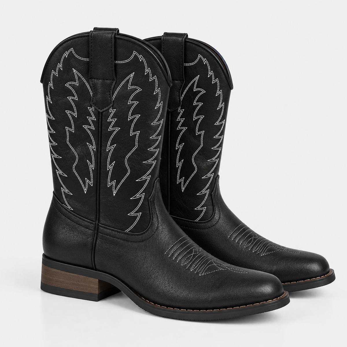 Women's black leather cowboy boots with embroidered shafts, pointed toes, and low block heels