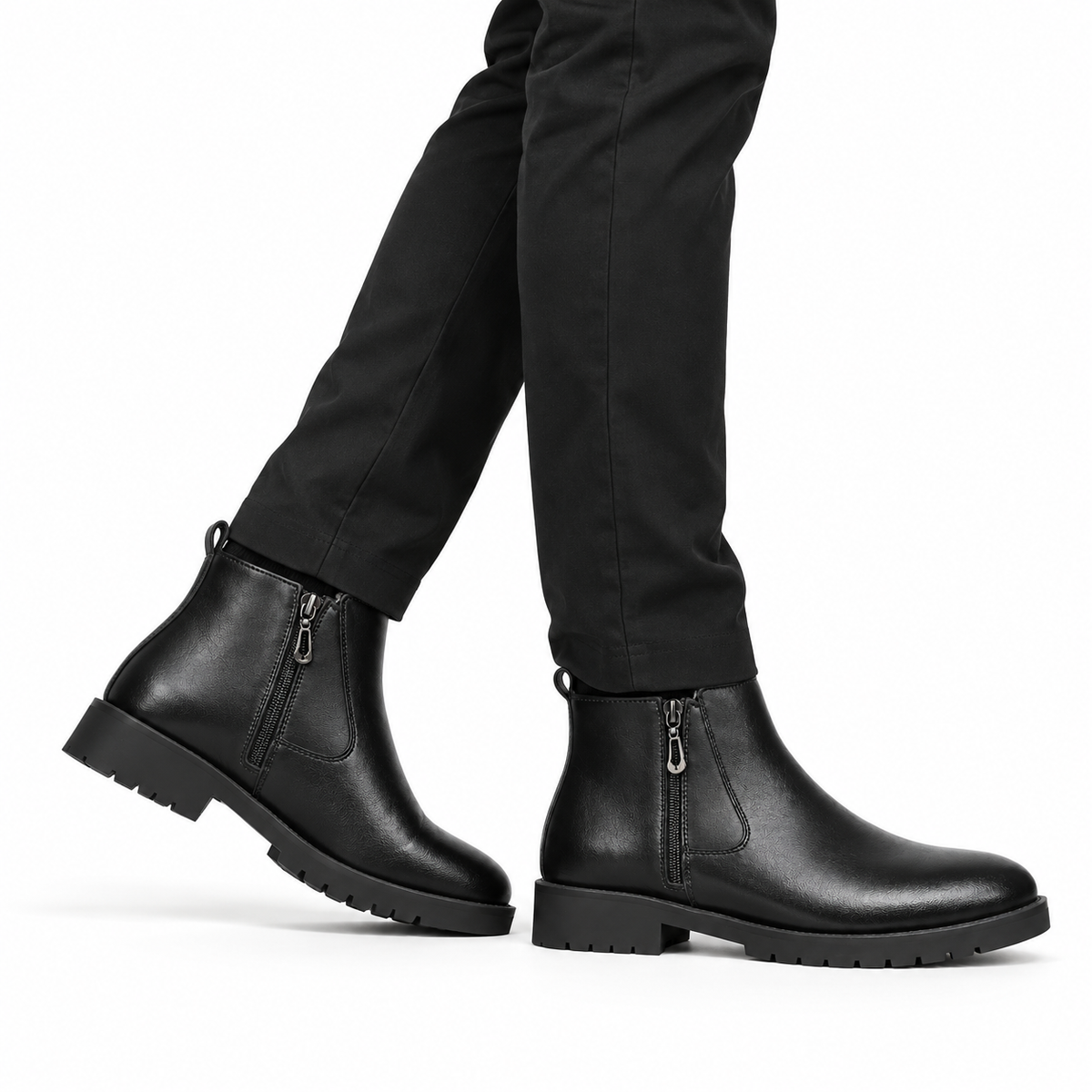 Side view of black leather ankle boots with side zipper and chunky rubber soles