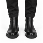 Front view of black leather ankle boots with rounded toes and thick soles